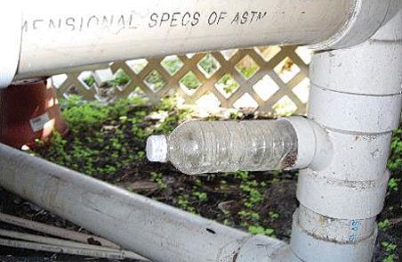 An innovative use for plastic water bottles, but it won't be long before water is pouring out of this pipe.